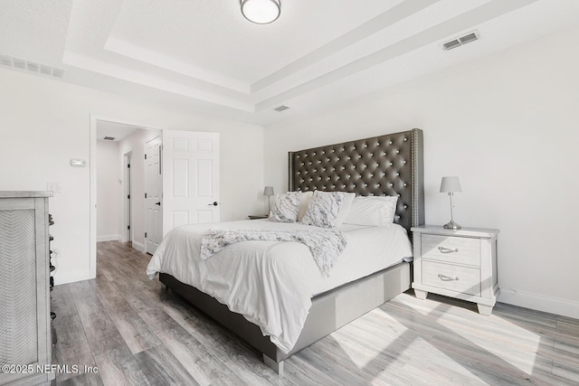 206 Woodland Greens Dr, Ponte Vedra, FL 32081 - bedroom featuring a tray ceiling, wood finished floors, and visible vents