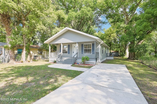 bungalow-style house with covered porch, fence, concrete driveway, and a front lawn