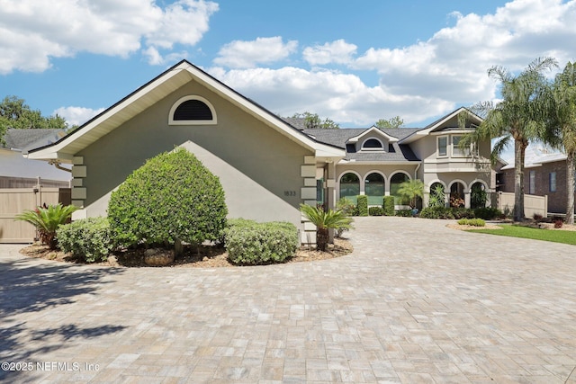 1833 N Lakeshore Dr, Fleming Island, FL 32003 - mediterranean / spanish house with fence, stucco siding, and driveway