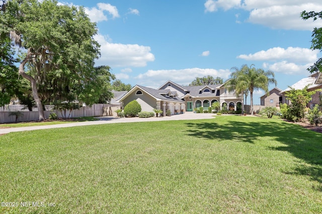 1833 N Lakeshore Dr, Fleming Island, FL 32003 - view of front facade with fence, driveway, and a front lawn