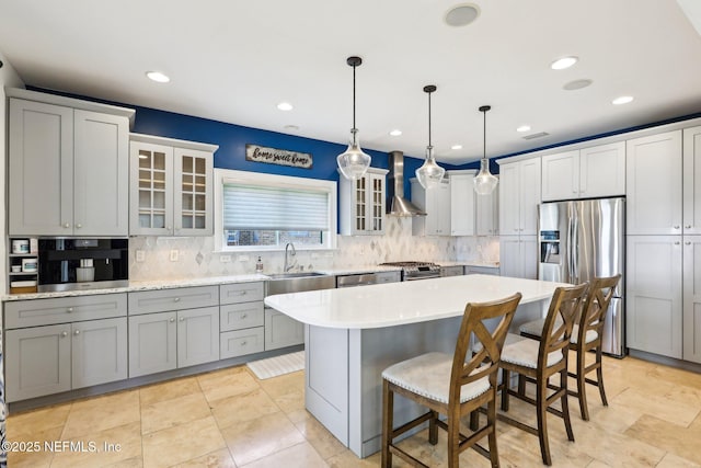 1833 N Lakeshore Dr, Fleming Island, FL 32003 - kitchen with decorative backsplash, a center island, light countertops, a breakfast bar, and stainless steel appliances