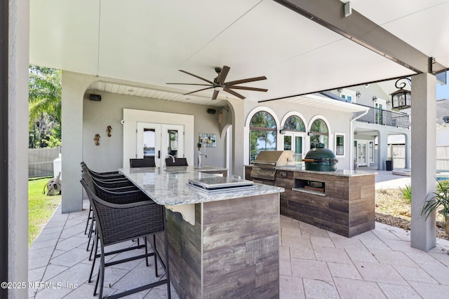 1833 N Lakeshore Dr, Fleming Island, FL 32003 - view of patio / terrace featuring outdoor wet bar, an outdoor kitchen, french doors, a ceiling fan, and a grill