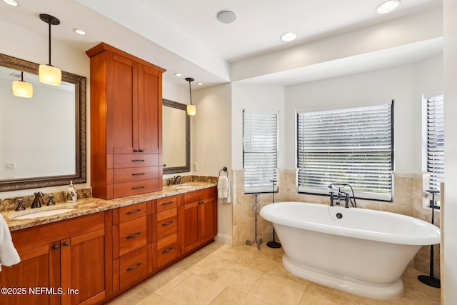1833 N Lakeshore Dr, Fleming Island, FL 32003 - full bath with a sink, tile walls, double vanity, and a freestanding tub