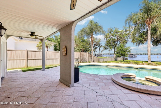 1833 N Lakeshore Dr, Fleming Island, FL 32003 - view of swimming pool featuring a patio, a fenced backyard, a ceiling fan, a water view, and a pool with connected hot tub