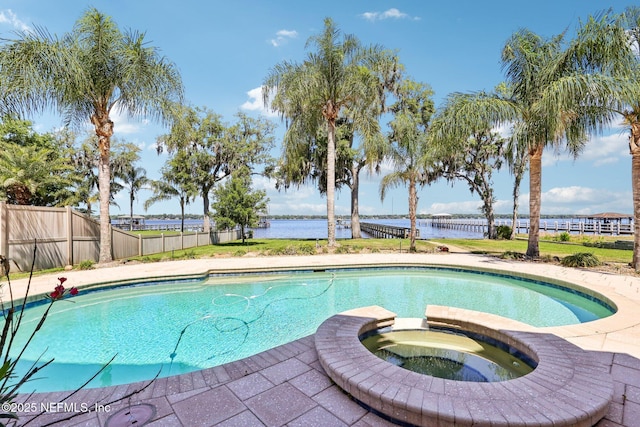 1833 N Lakeshore Dr, Fleming Island, FL 32003 - view of swimming pool featuring fence, a water view, and a pool with connected hot tub