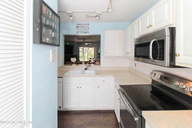 1403 Marsh Cove Ct, Ponte Vedra Beach, FL 32082 - kitchen with appliances with stainless steel finishes, a sink, white cabinets, and dark wood finished floors