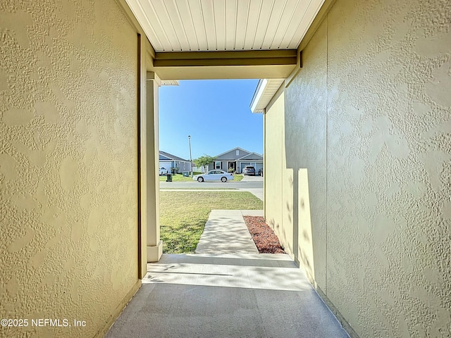 view of home's exterior with a porch and stucco siding