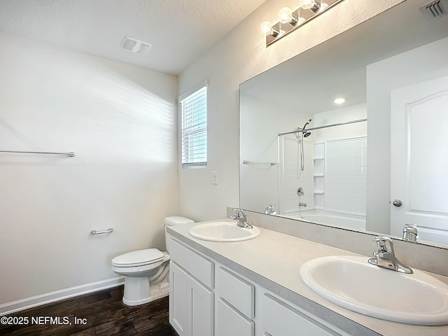 full bath with visible vents, a sink, and toilet