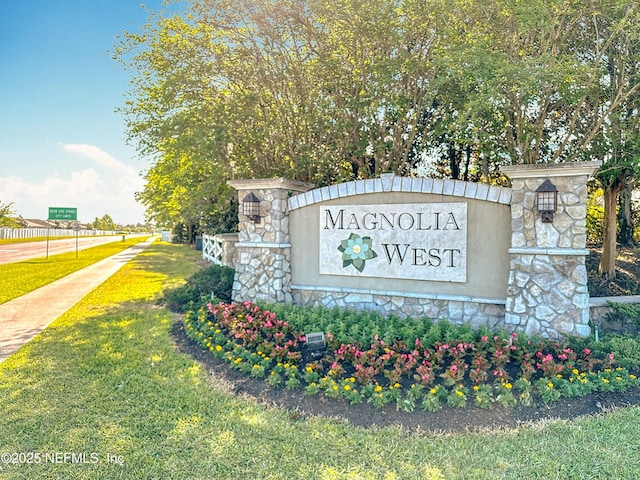 community / neighborhood sign with a yard