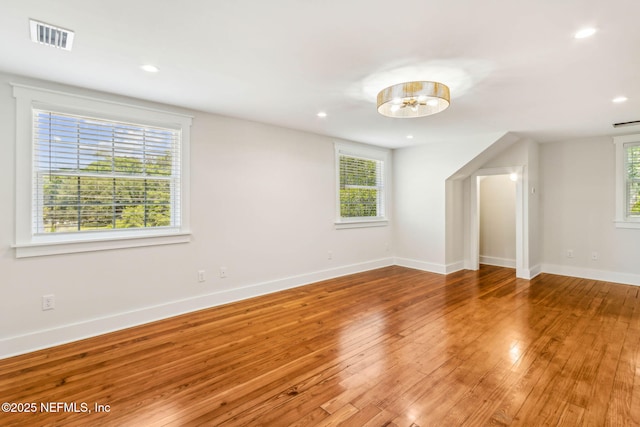 empty room featuring recessed lighting, baseboards, visible vents, and light wood-style flooring