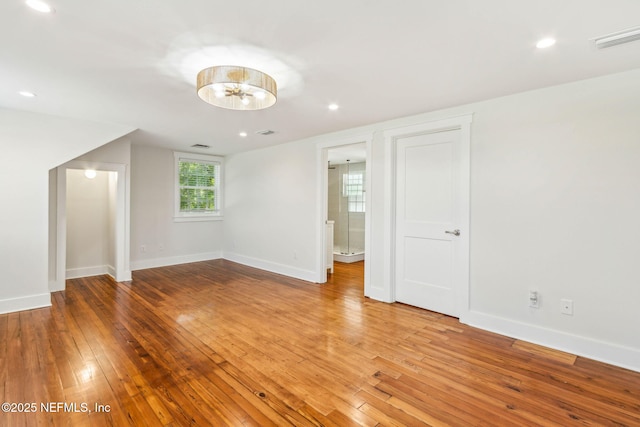 interior space with baseboards, recessed lighting, hardwood / wood-style floors, and visible vents