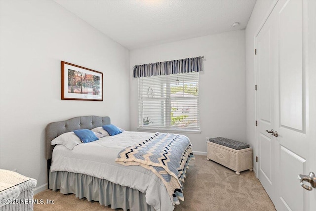 carpeted bedroom with baseboards