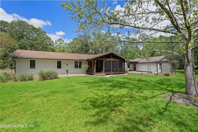 rear view of house with a sunroom, a pergola, and a yard