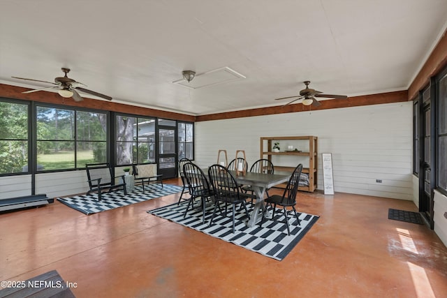 dining space with a ceiling fan and concrete floors