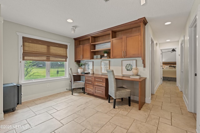 office space featuring built in study area, stone tile flooring, recessed lighting, baseboards, and ceiling fan