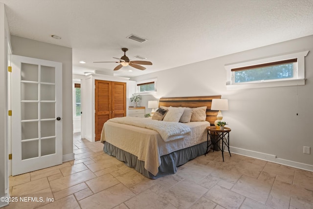 bedroom featuring multiple windows, baseboards, a closet, recessed lighting, and ceiling fan