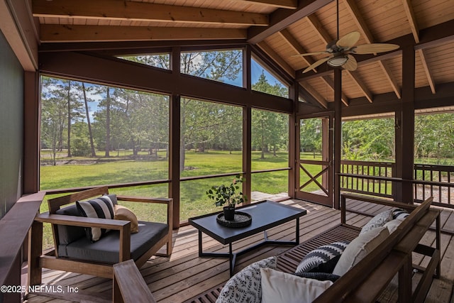 sunroom featuring ceiling fan and an outdoor living space