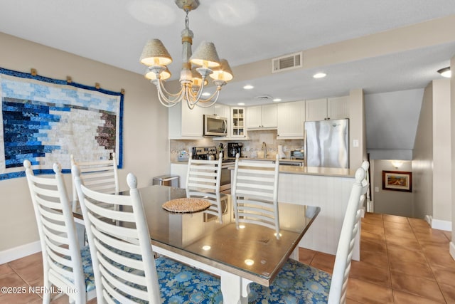 1029 Captains Court Dr Unit 1029, Fernandina Beach, FL 32034 - dining area with a chandelier, light tile patterned floors, baseboards, and recessed lighting