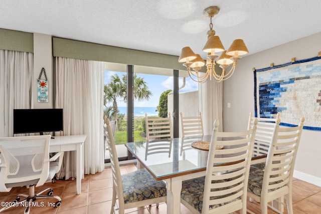 1029 Captains Court Dr Unit 1029, Fernandina Beach, FL 32034 - dining area with a chandelier, light tile patterned flooring, and a textured ceiling