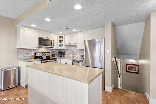 1029 Captains Court Dr Unit 1029, Fernandina Beach, FL 32034 - kitchen with appliances with stainless steel finishes, light tile patterned flooring, tasteful backsplash, recessed lighting, and a textured ceiling