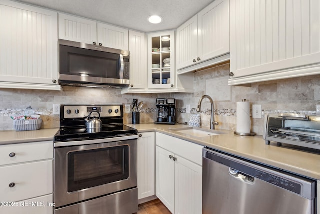 1029 Captains Court Dr Unit 1029, Fernandina Beach, FL 32034 - kitchen with appliances with stainless steel finishes, a sink, white cabinets, and light countertops