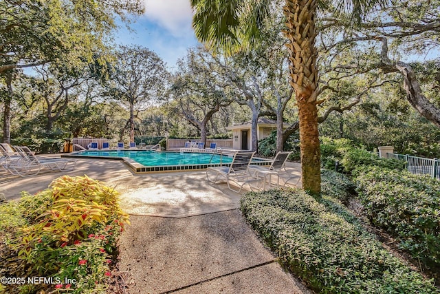1029 Captains Court Dr Unit 1029, Fernandina Beach, FL 32034 - community pool with fence, a patio, and view of scattered trees