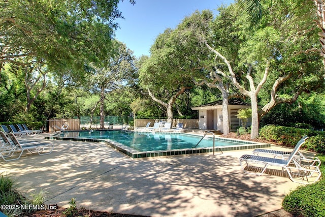 1029 Captains Court Dr Unit 1029, Fernandina Beach, FL 32034 - community pool featuring fence, a patio area, and view of scattered trees