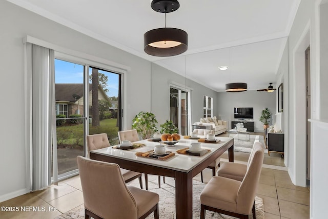 dining space with baseboards and light tile patterned flooring