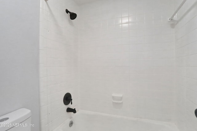 bathroom featuring toilet and tub / shower combination