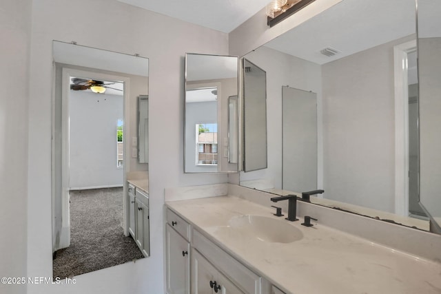 bathroom with visible vents, a ceiling fan, and vanity