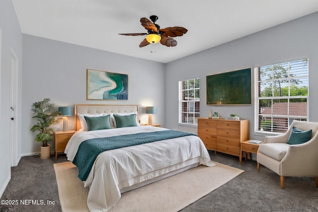 carpeted bedroom with ceiling fan and baseboards