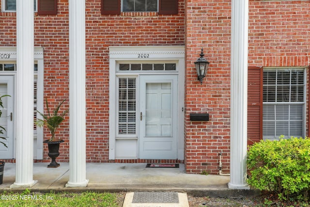 property entrance with brick siding