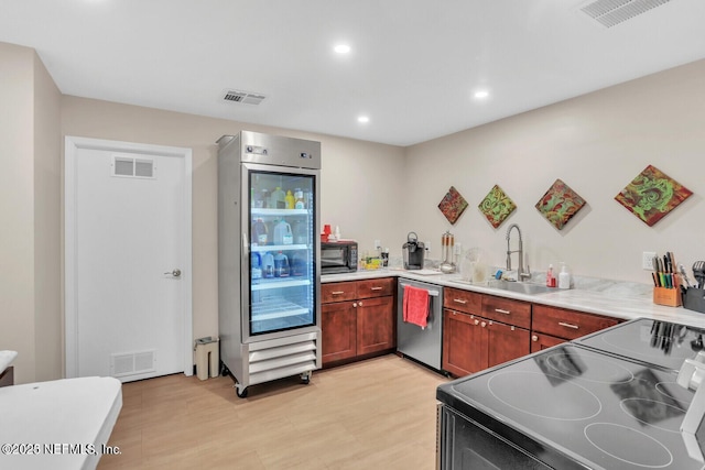 9252 San Jose Blvd Unit 2002, Jacksonville, FL 32257 - kitchen featuring a sink, black appliances, light wood finished floors, light countertops, and recessed lighting