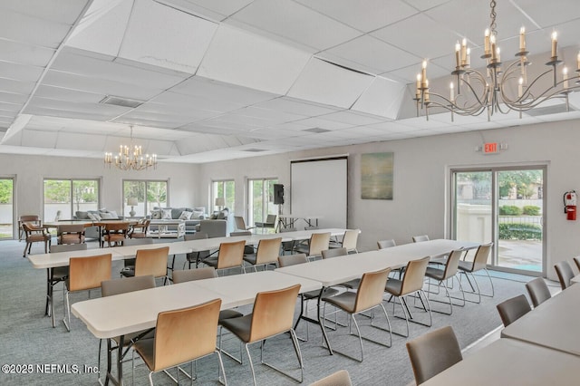 9252 San Jose Blvd Unit 2002, Jacksonville, FL 32257 - dining space featuring a chandelier, carpet flooring, and a drop ceiling