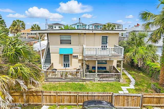 view of front of home with a fenced backyard and a wooden deck