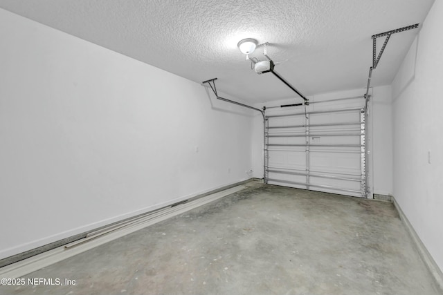 garage with baseboards and a garage door opener