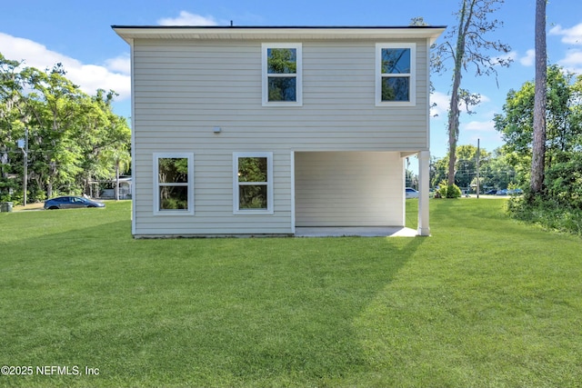 back of house featuring a yard