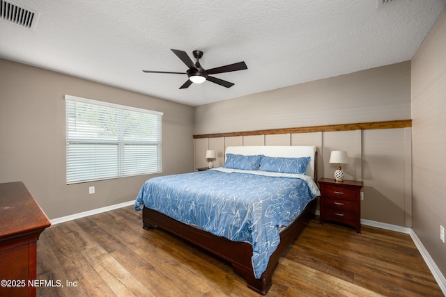 19533 NW 229th St, High Springs, FL 32643 - bedroom featuring wood finished floors, a textured ceiling, and ceiling fan