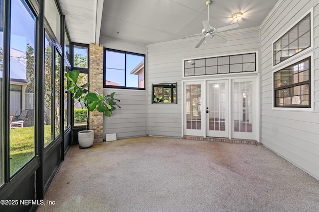 unfurnished sunroom with ceiling fan and french doors