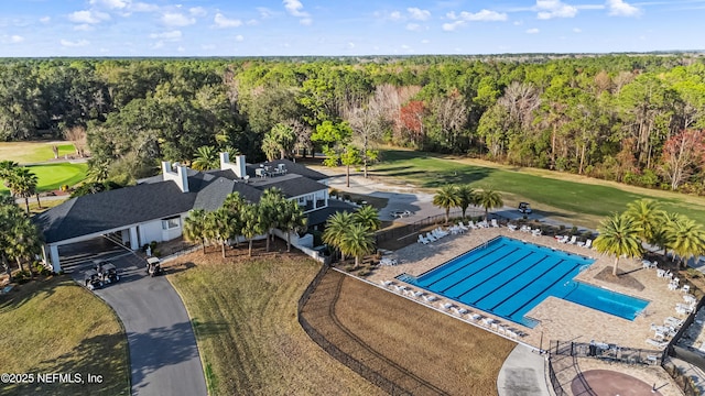 aerial view featuring a view of trees and golf course view