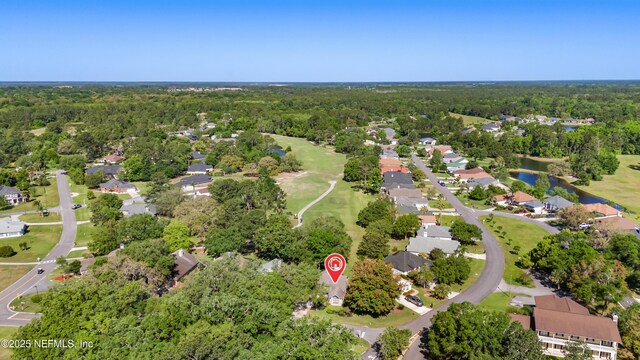 birds eye view of property featuring a residential view and a forest view