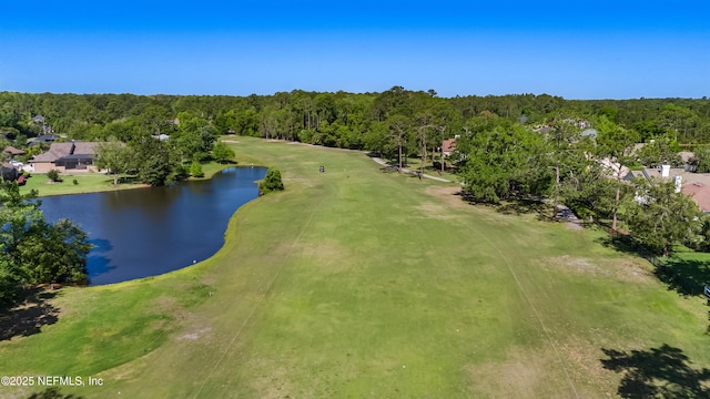 bird's eye view with a view of trees, view of golf course, and a water view