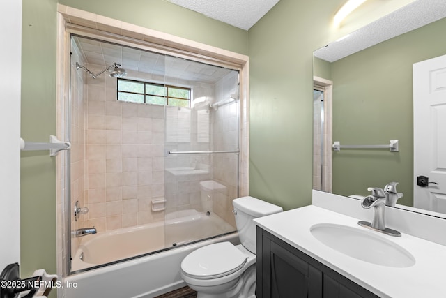 bathroom with vanity, enclosed tub / shower combo, a textured ceiling, and toilet