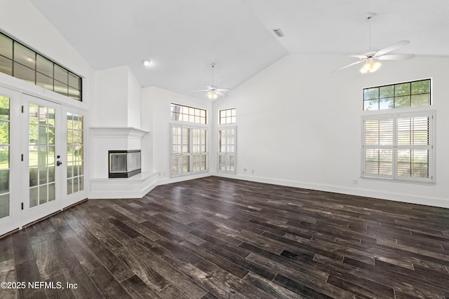 unfurnished living room with wood finished floors, high vaulted ceiling, and ceiling fan
