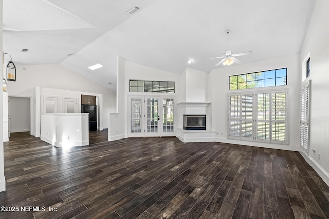 unfurnished living room with high vaulted ceiling, dark wood finished floors, a ceiling fan, and a glass covered fireplace