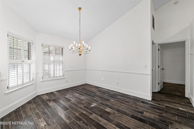 unfurnished dining area with dark wood finished floors, lofted ceiling, baseboards, and an inviting chandelier