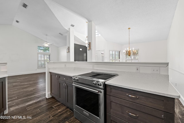 kitchen featuring vaulted ceiling, electric range, dark wood-style floors, and ceiling fan with notable chandelier