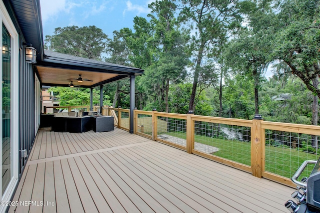 deck with a lawn and ceiling fan