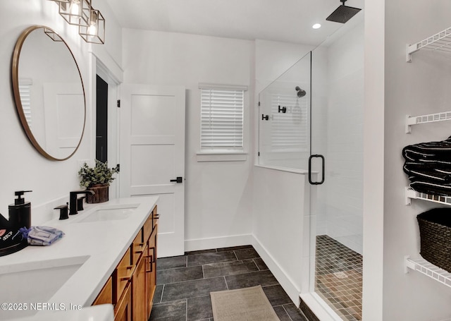 full bathroom featuring a shower stall, a sink, double vanity, baseboards, and recessed lighting