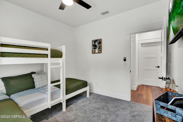 bedroom with visible vents, carpet flooring, baseboards, and a ceiling fan